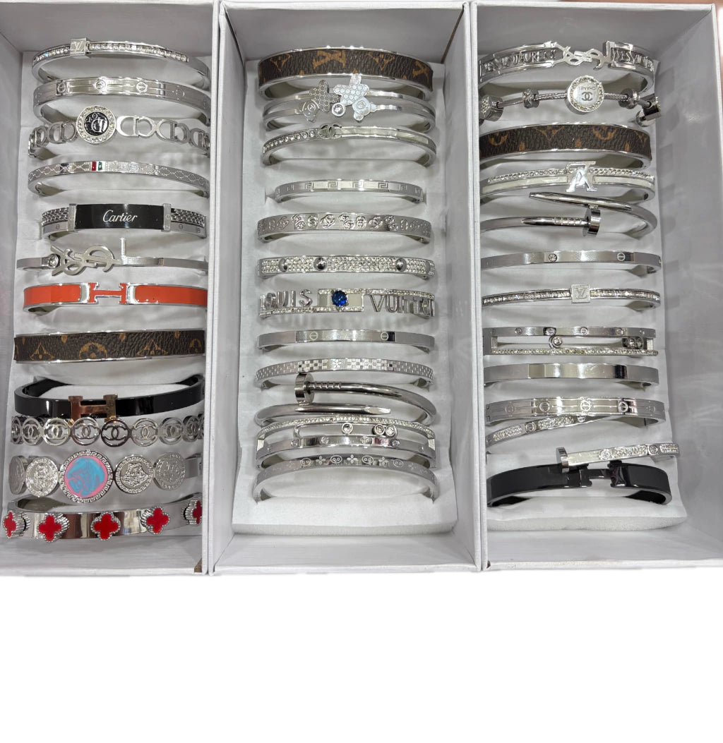Esclavas acero plateado x12u. Al azar .