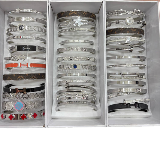 Esclavas acero plateado x12u. Al azar .