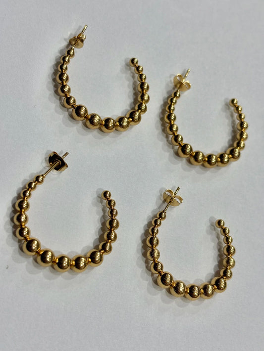 -558B argollas acero dorado x12