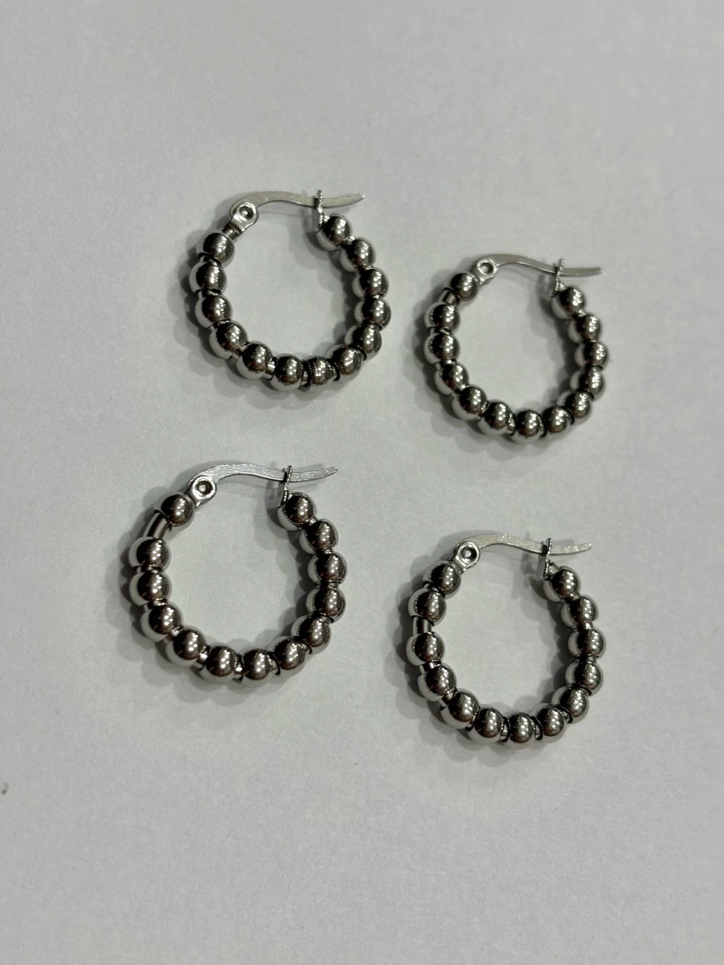 -557A argollas acero plateado x12