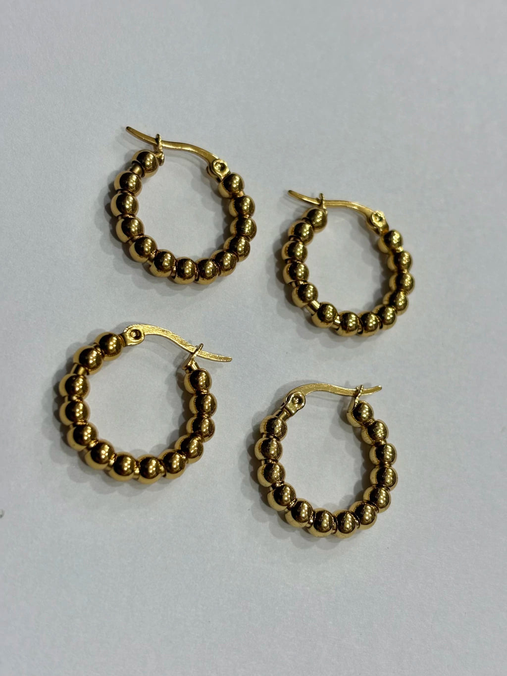 -557B argollas acero dorado x12