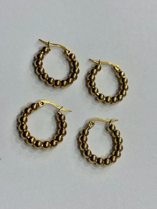 -557B argollas acero dorado x12