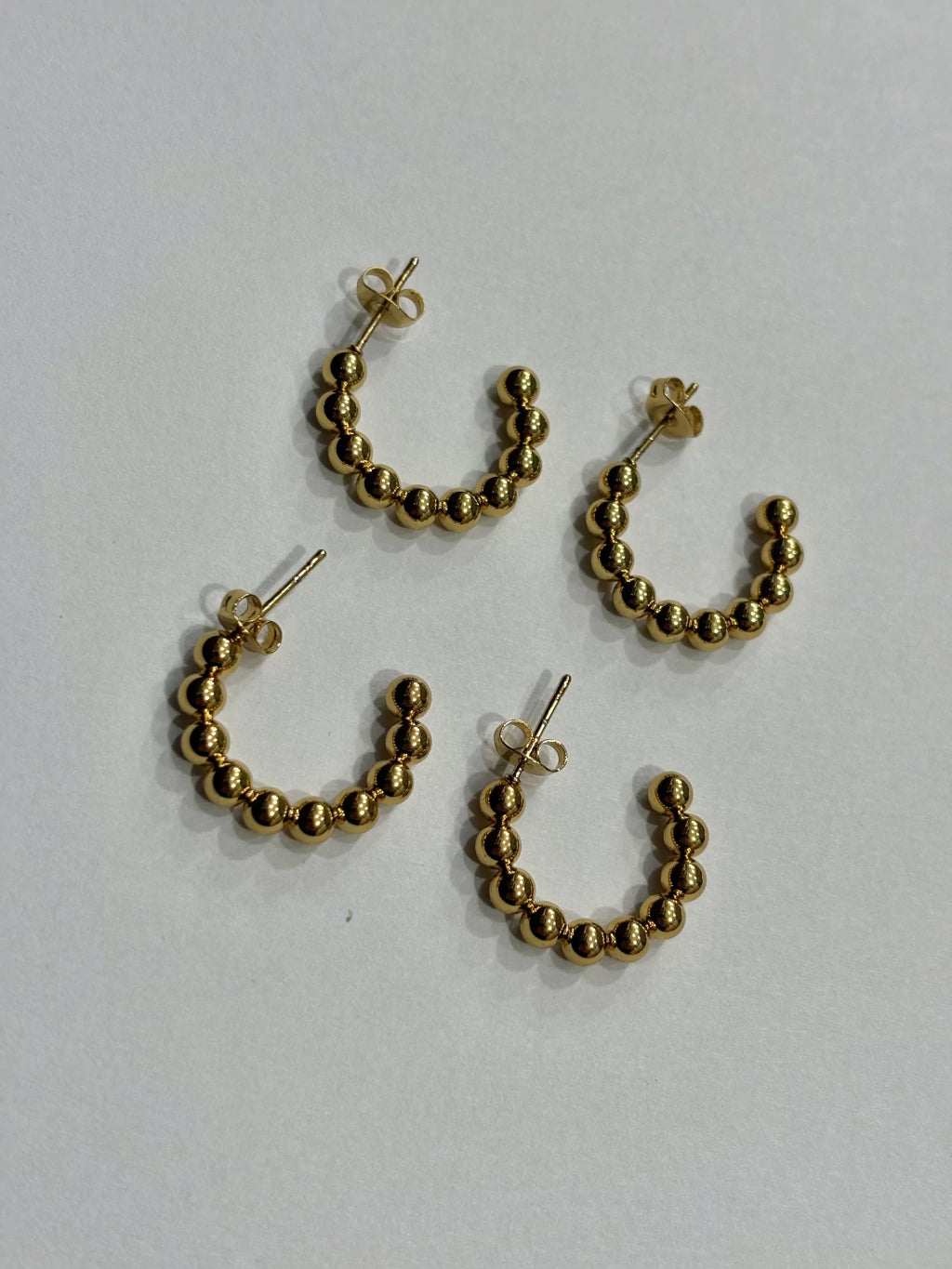 -560B argollas acero dorado x12
