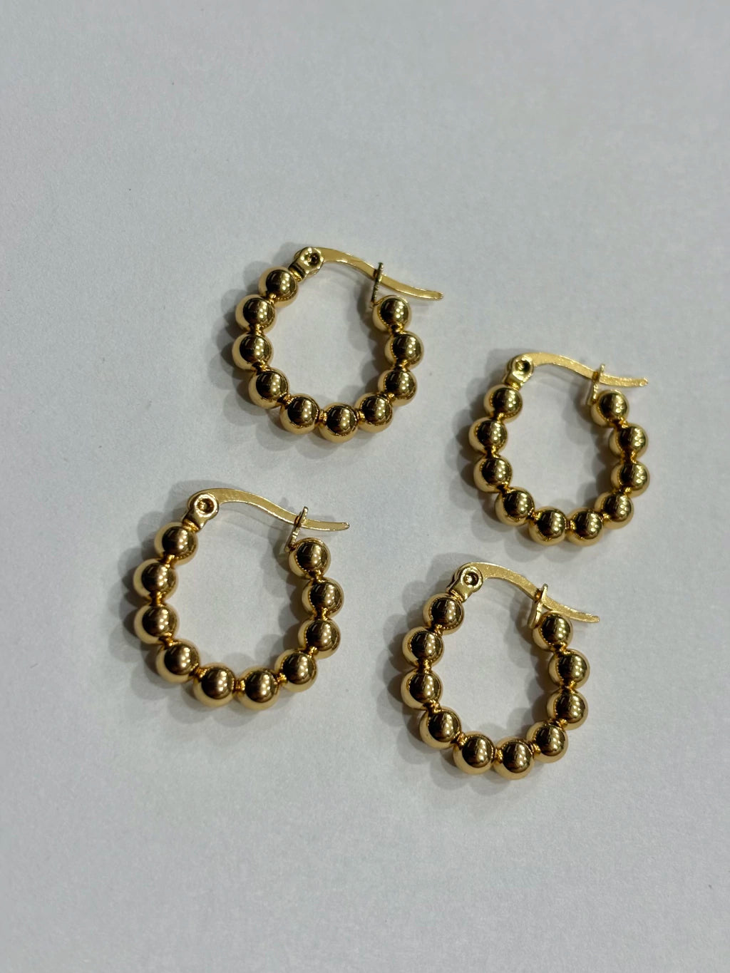 -556B argollas acero dorado x12