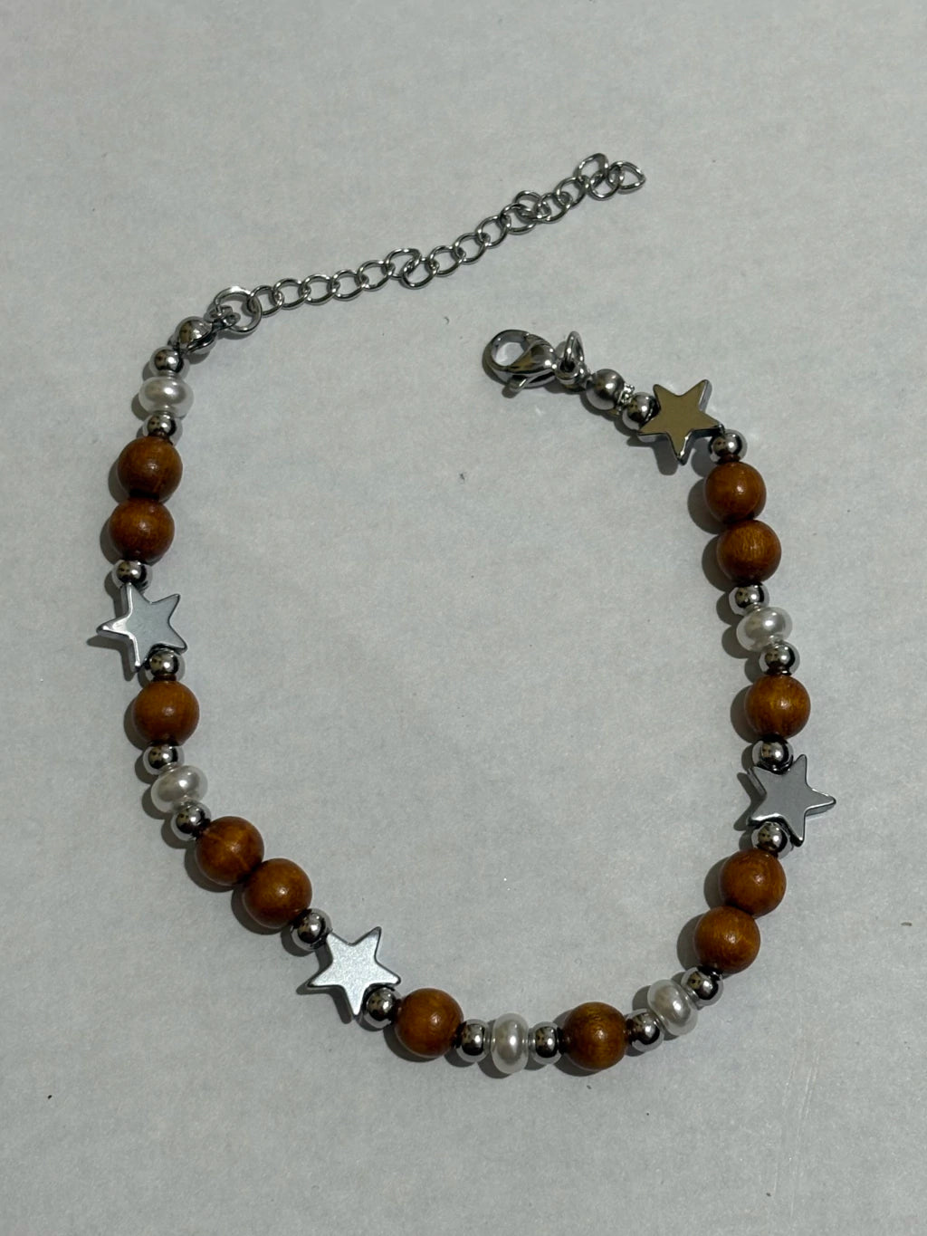 Pulsera elastizado de acero plateado con dije